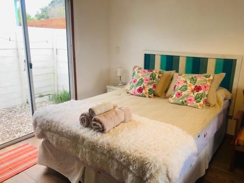 a bedroom with a large bed with towels on it at Posada Agua Marina in La Paloma