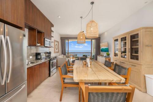 a kitchen with a long wooden table and chairs at Unique BEACH FRONT condo with concierge in San José del Cabo