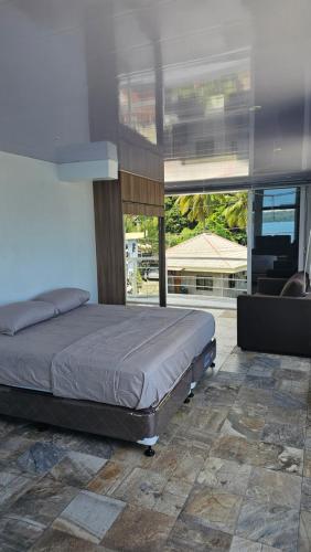 a bedroom with a bed and a large window at Lydia's House in Kaputian