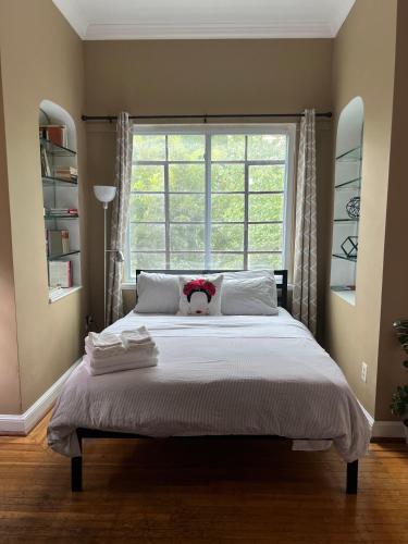 a bedroom with a bed with a teddy bear on it at The Orange House in Washington, D.C.