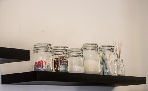 a shelf with several glass jars on it at Modern 4BR Double Storey @ Setia Alam in Shah Alam