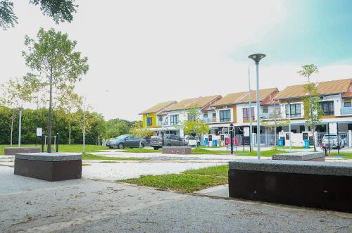 a parking lot with a bunch of buildings and cars at Modern 4BR Double Storey @ Setia Alam in Shah Alam