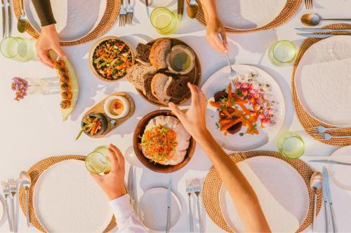 a group of people sitting at a table eating food at The Ritz-Carlton Tenerife, Abama in Guía de Isora