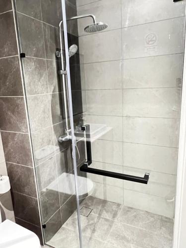 a shower with a glass door in a bathroom at Axon suites Bukit bintang Rooftop Swimming pool in Kuala Lumpur