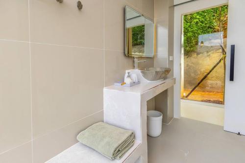 a white bathroom with a sink and a mirror at Mountain Skyline Glass House V1 Doi Sakad, Nan in Ban Sakat Nua