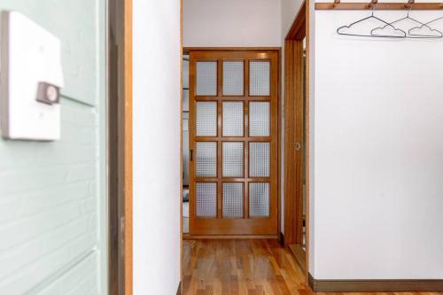 a hallway with a door in a house at KAKUREGA by unito in Hakodate