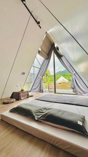 a bedroom with a large bed in a tent at Ora Hill Retreat in Cao Phong