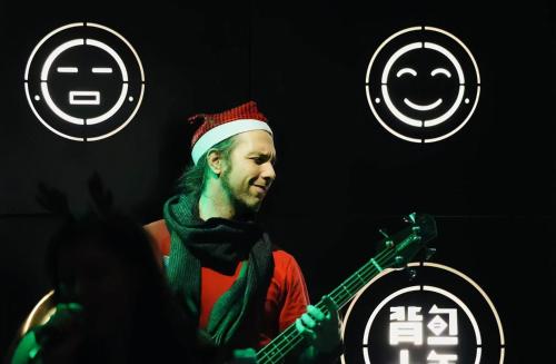 a man in a santa hat playing a guitar at Chongqing Desti Youth Park Hostel Liberation Monument in Chongqing