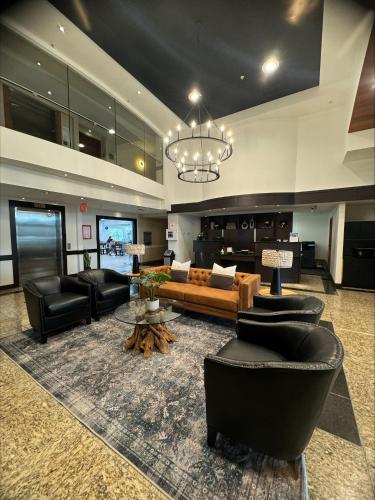 a large living room with a couch and chairs at Prestige Prince George Lodge in Prince George