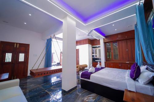 a bedroom with a large bed and a swing at Skylar Seaview Beach Resort & Ayurveda Varkala in Varkala