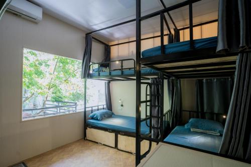 a room with two bunk beds and a window at City Garden Hostel in Ninh Binh
