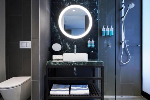 a bathroom with a sink and a mirror at Novotel Melbourne Airport in Melbourne