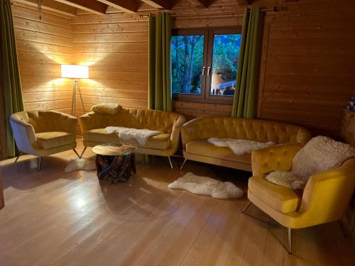a living room with yellow couches and a window at Skigebiete Stuhleck und Semmering,Wandergebiete Schneeberg und Rax in Neunkirchen