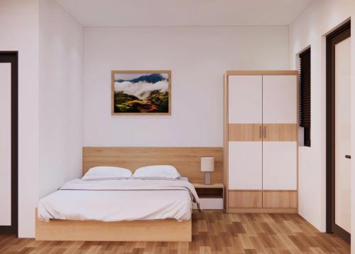 a bedroom with a bed and a mirror at Sơn Trang House in Sa Pa