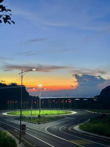 an empty road with a sunset in the background at Eden Hotel Cát Bà in Cat Ba