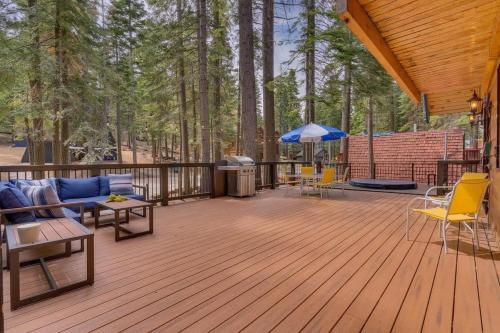 a deck with a couch and chairs and an umbrella at Modern Retro Tahoe Chic Chalet in Tahoe City
