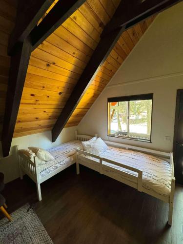 a large bedroom with two beds in a attic at Modern Retro Tahoe Chic Chalet in Tahoe City