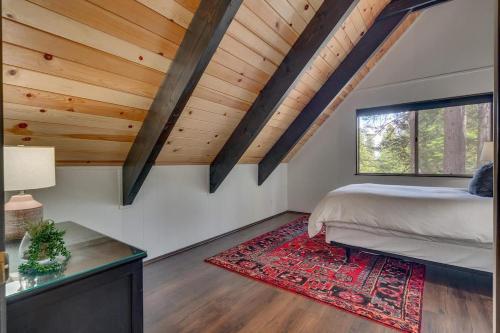a bedroom with a bed and a table at Modern Retro Tahoe Chic Chalet in Tahoe City
