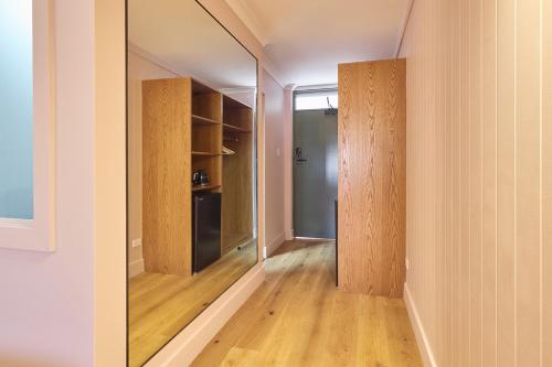 an empty room with a mirror and a closet at Alpine Inn in Khancoban