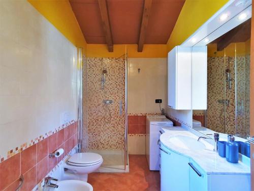 a bathroom with a sink and a toilet and a shower at Apartment in Bosco with Scenic Terrace in Montegrino Valtravaglia