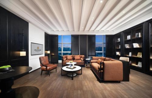 a living room with a couch and chairs and a table at Anlandon International Hotel in Qingbaijiang