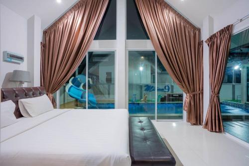 a bedroom with a bed and a swimming pool at บ้านพักพลูวิลล่าชะอำ หัวหิน Million9 in Cha Am
