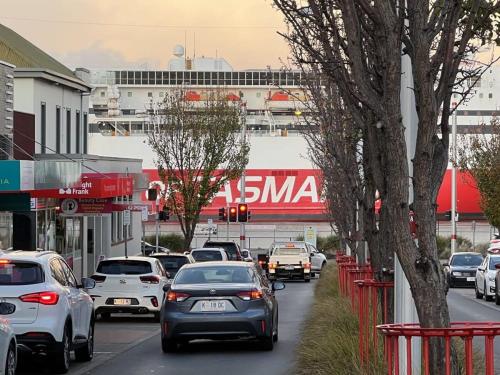 a group of cars driving down a busy city street at New Listing Loft Apt & A C in Heart of Devonport in Devonport
