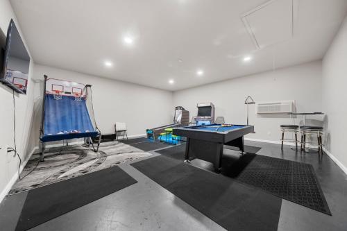 a room with a ping pong table in a room at Pool, Hot Tub, Game Room & Sleeps 18! By StayLage in Hot Springs