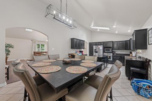 a kitchen and dining room with a table and chairs at Pool, Hot Tub, Game Room & Sleeps 18! By StayLage in Hot Springs