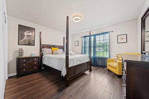 a bedroom with a bed and a dresser and a window at Pool, Hot Tub, Game Room & Sleeps 18! By StayLage in Hot Springs