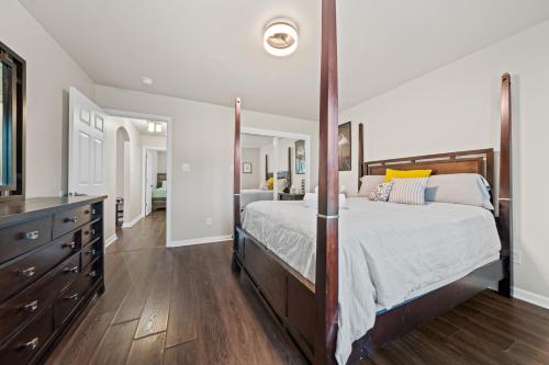 a bedroom with a large bed and a large mirror at Pool, Hot Tub, Game Room & Sleeps 18! By StayLage in Hot Springs