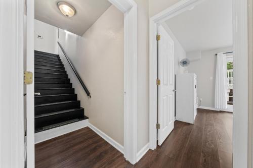 a white hallway with stairs in a house at Pool, Hot Tub, Game Room & Sleeps 18! By StayLage in Hot Springs