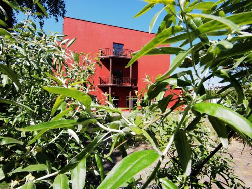 a red building with a balcony in the background at Hotel Altamira in Piotrków Trybunalski
