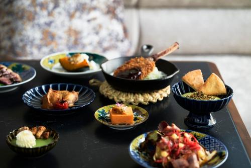 a table topped with different types of food on plates at Canopy By Hilton Osaka Umeda in Osaka