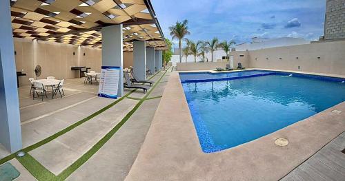 a swimming pool in the middle of a house at Casa Punta Arena in Los Bledales