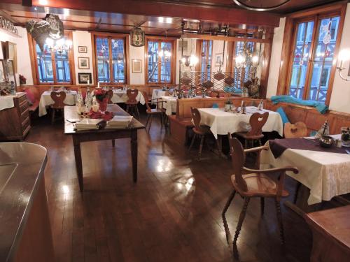 a restaurant with tables and chairs in a room at Hotel Restaurant Rössle in Calw