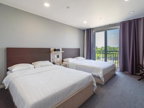 Postel nebo postele na pokoji v ubytování Cordelia Hotel