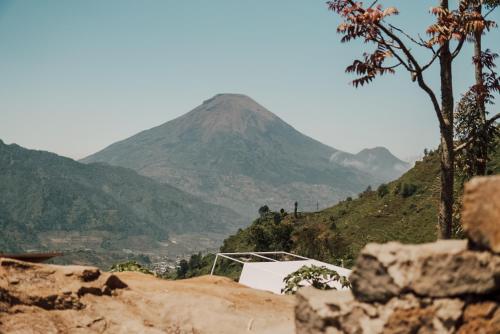 a view of a mountain in the distance at Luxcamp Dieng by Horison in Garung