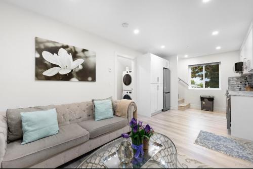 a living room with a couch and a table at Entire new small home in Vancouver