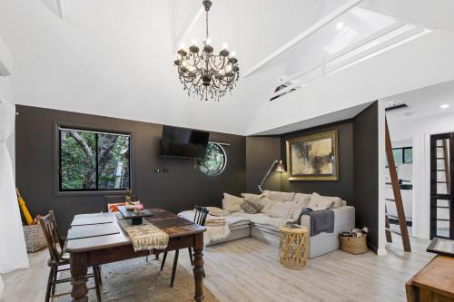 a living room with a couch and a table at Shellies On The Beach - Little House in Sawtell