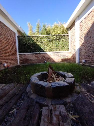 a fire pit in a yard next to a brick building at Hotel Lido in General Rodríguez