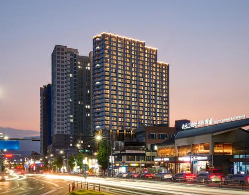 a large building in a city at night at The Hotel Sokcho in Sokcho