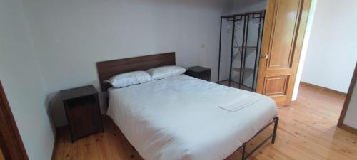 a bedroom with a bed with two pillows on it at Casa do Outeiro de Aguil in Castro Caldelas