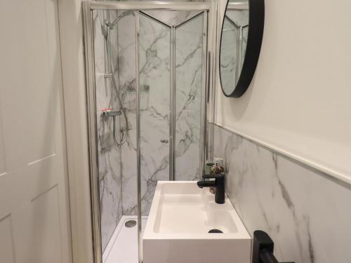 a bathroom with a sink and a shower at Limhus House in Keswick