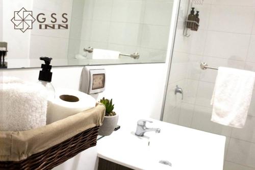 a bathroom with a sink and a toilet and a mirror at Beautiful apartment Near airport /cozy Oceanfront in Lima