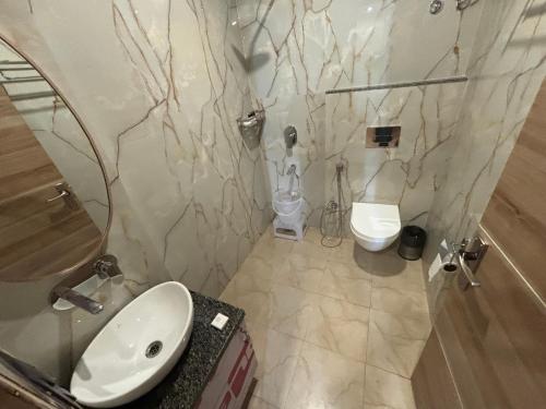 a bathroom with a sink and a toilet at Hotel Anju Shree Inn-Near Jaipur Airport Terminal 1 in Jaipur