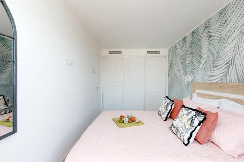 a bedroom with a bed with a tray of food on it at ON VACAY - Votre havre de paix à 100 m des plages in Cannes