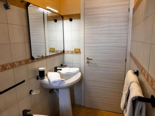 a bathroom with a white sink and a mirror at MF House in Taormina
