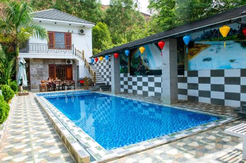 a swimming pool in front of a house at The Ridge Haven in Phong Nha