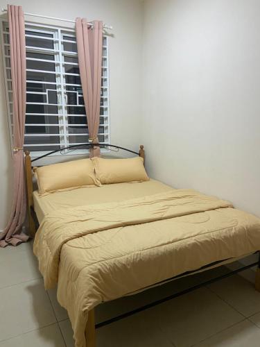 a bed in a room with a window at Suasana Damai Damansara Damai Petaling Jaya in Petaling Jaya